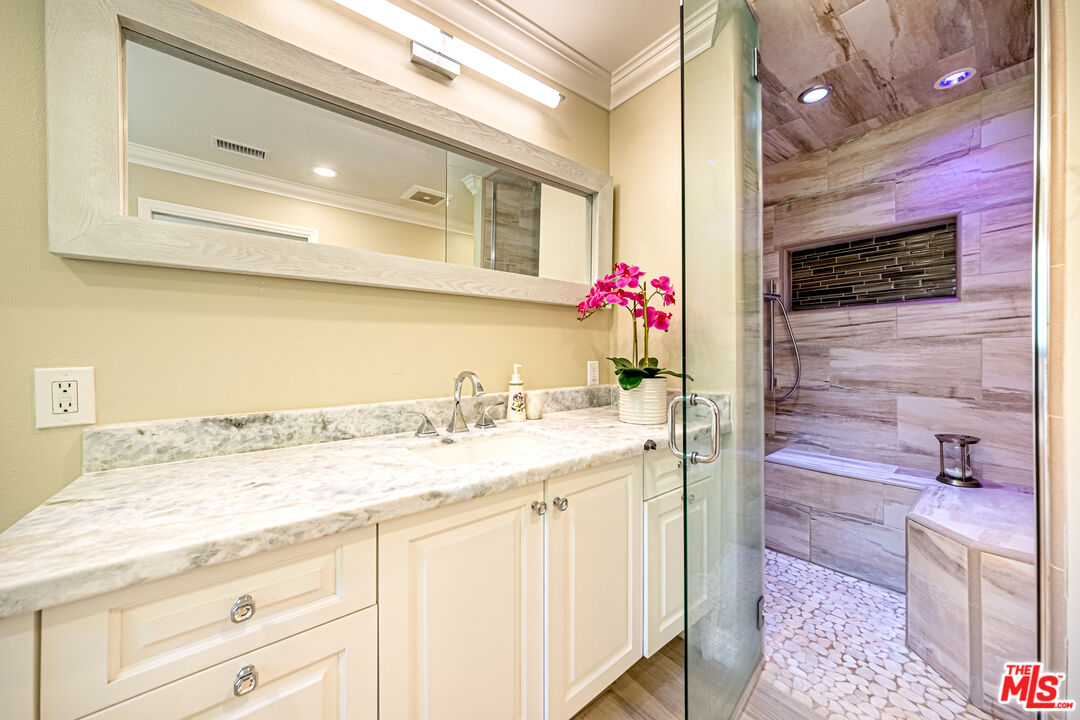 1195 Vía Pintada Riverside, CA 92507 - Photo 25 of 51 a bathroom with a granite countertop sink a mirror and a shower
