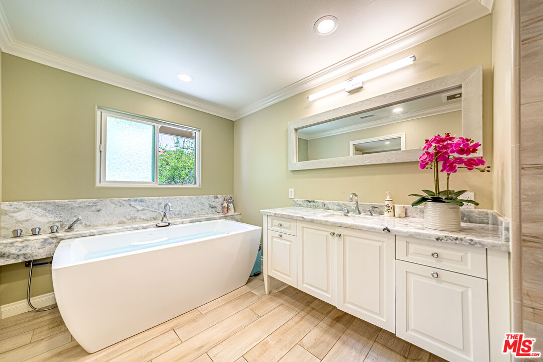 1195 Vía Pintada Riverside, CA 92507 - Photo 27 of 51 a spacious bathroom with a granite countertop sink mirror and a bathtub