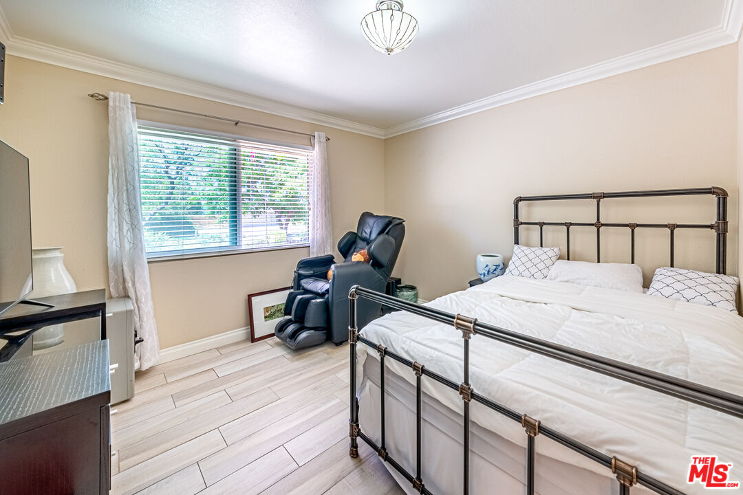 1195 Vía Pintada Riverside, CA 92507 - Photo 29 of 51 a bedroom with a bed and wooden floor