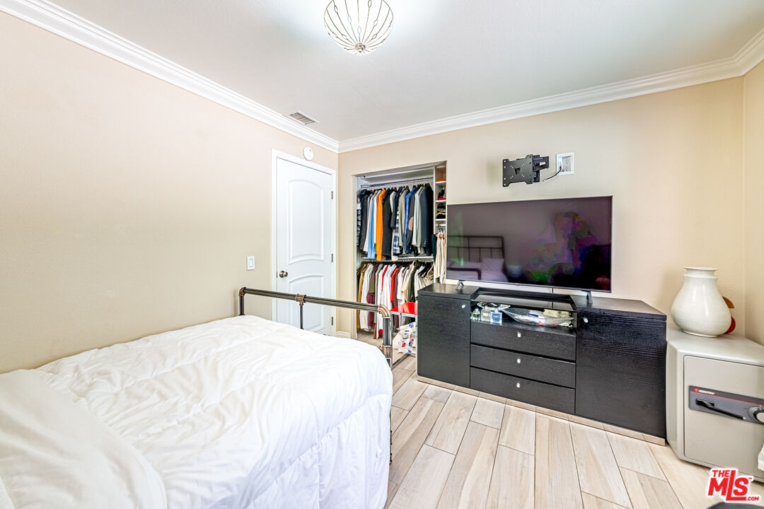 1195 Vía Pintada Riverside, CA 92507 - Photo 30 of 51 a bedroom with a bed and a flat screen tv