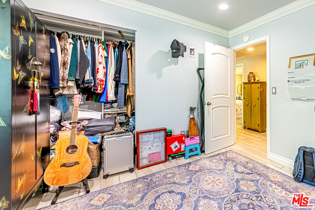 1195 Vía Pintada Riverside, CA 92507 - Photo 32 of 51 a view of walk in closet with clothes and shoes