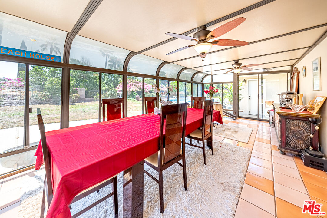 1195 Vía Pintada Riverside, CA 92507 - Photo 10 of 51 a view of a dining room with furniture large windows and wooden floor