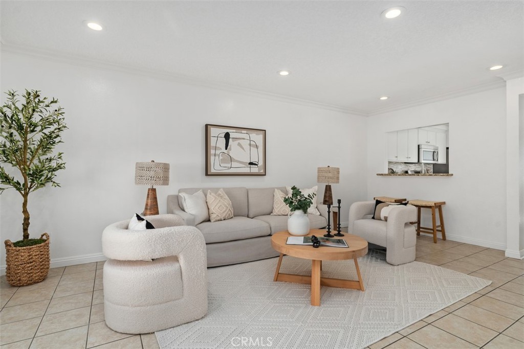 a living room with furniture and flowers