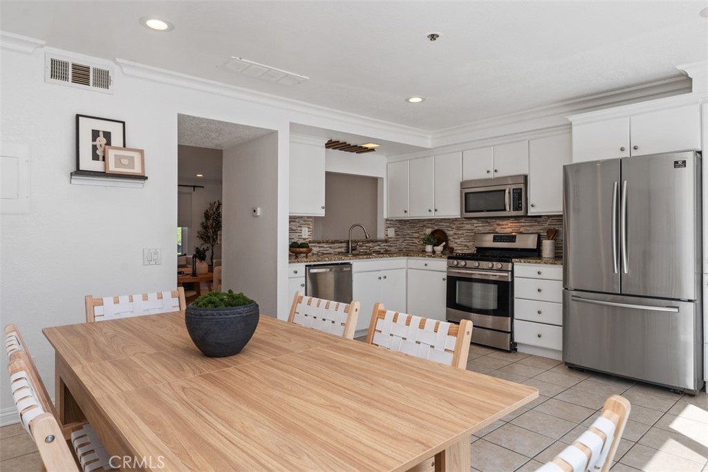 25885 Trabuco Road, Unit 203 Lake Forest, CA 92630 - Photo 15 of 43 a kitchen with stainless steel appliances a stove refrigerator sink and microwave