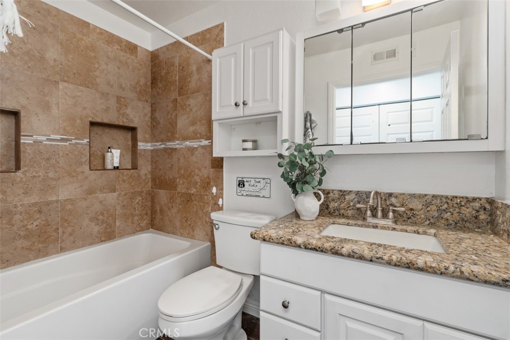 25885 Trabuco Road, Unit 203 Lake Forest, CA 92630 - Photo 20 of 43 a bathroom with a granite countertop sink a toilet and bathtub