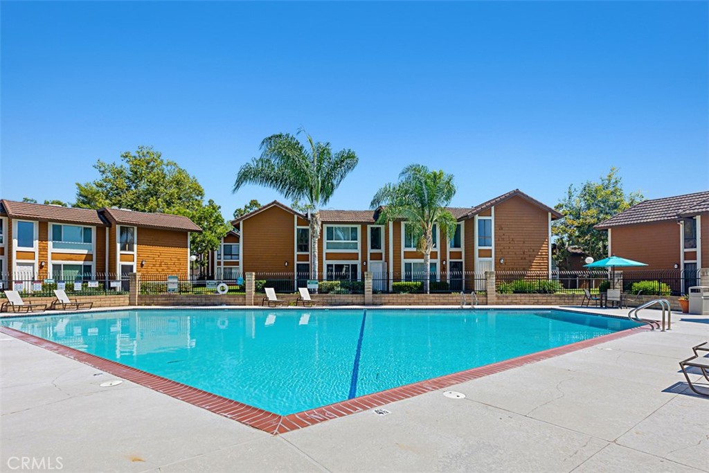 25885 Trabuco Road, Unit 203 Lake Forest, CA 92630 - Photo 33 of 43 a view of a house with swimming pool and a yard