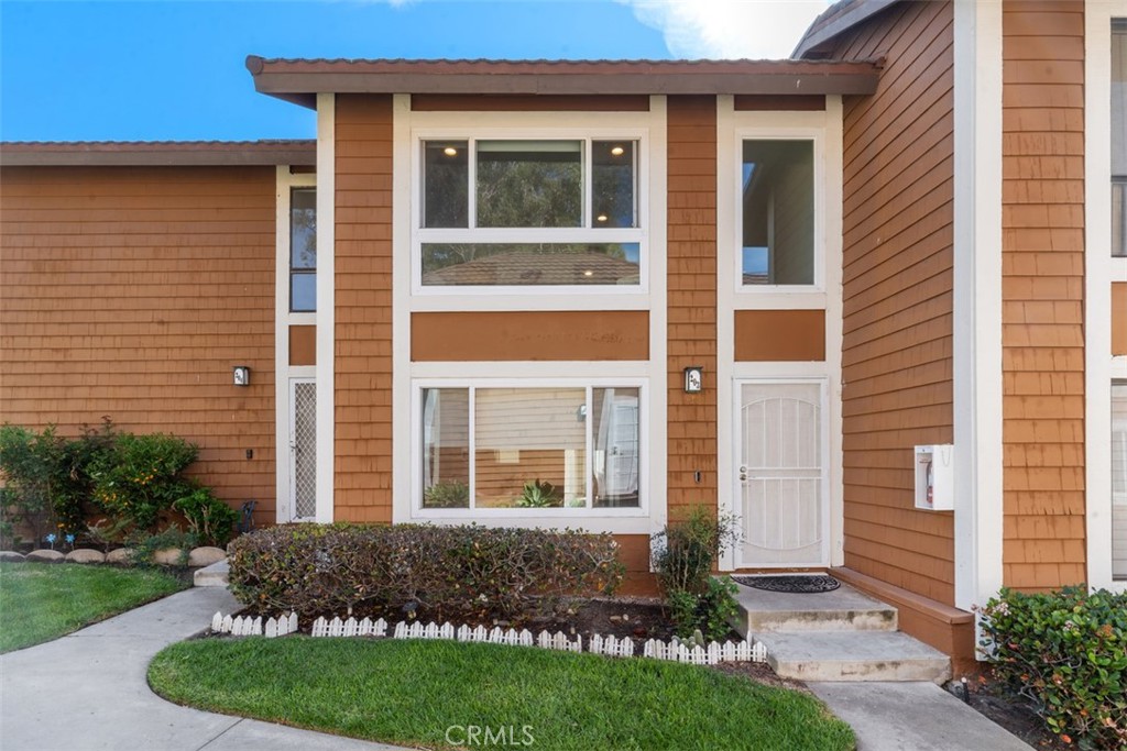 25885 Trabuco Road, Unit 203 Lake Forest, CA 92630 - Photo 5 of 43 a front view of a house with a yard