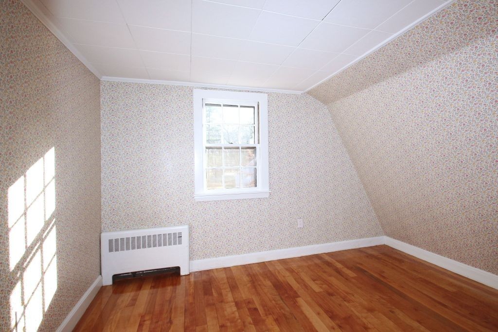 18 Parmenter Road Wayland, MA 01778 - Photo 14 of 28 an empty room with wooden floor and windows