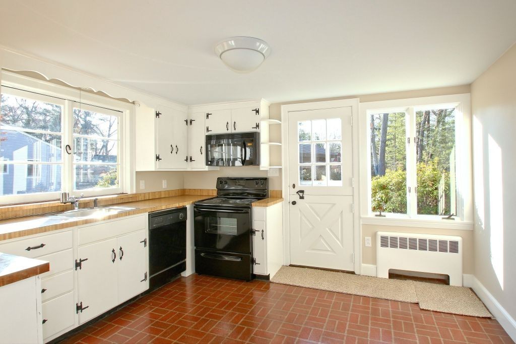 18 Parmenter Road Wayland, MA 01778 - Photo 7 of 28 a kitchen with stainless steel appliances a stove a sink and a window