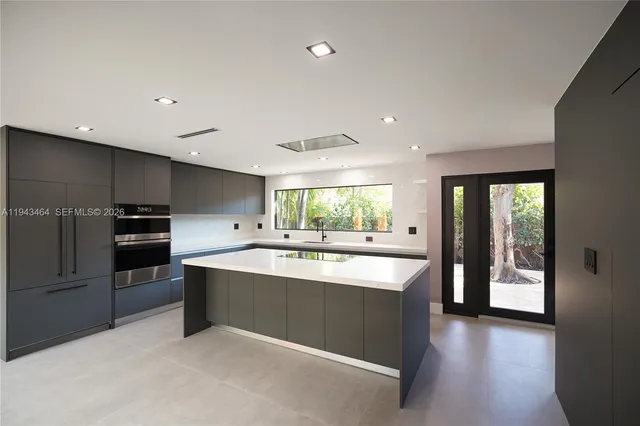 a kitchen with kitchen island a sink and wooden floor