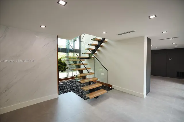 an empty room with floor to ceiling windows and painted walls
