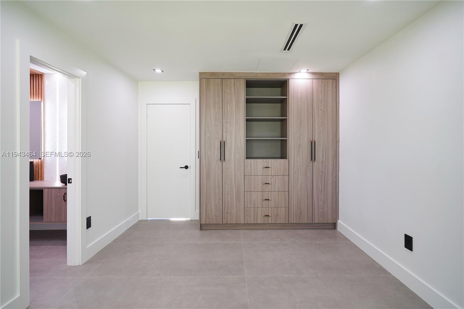7765 Southwest 57th Terrace Miami, FL 33143 - Photo 50 of 52 a view of an empty room with window and cabinet