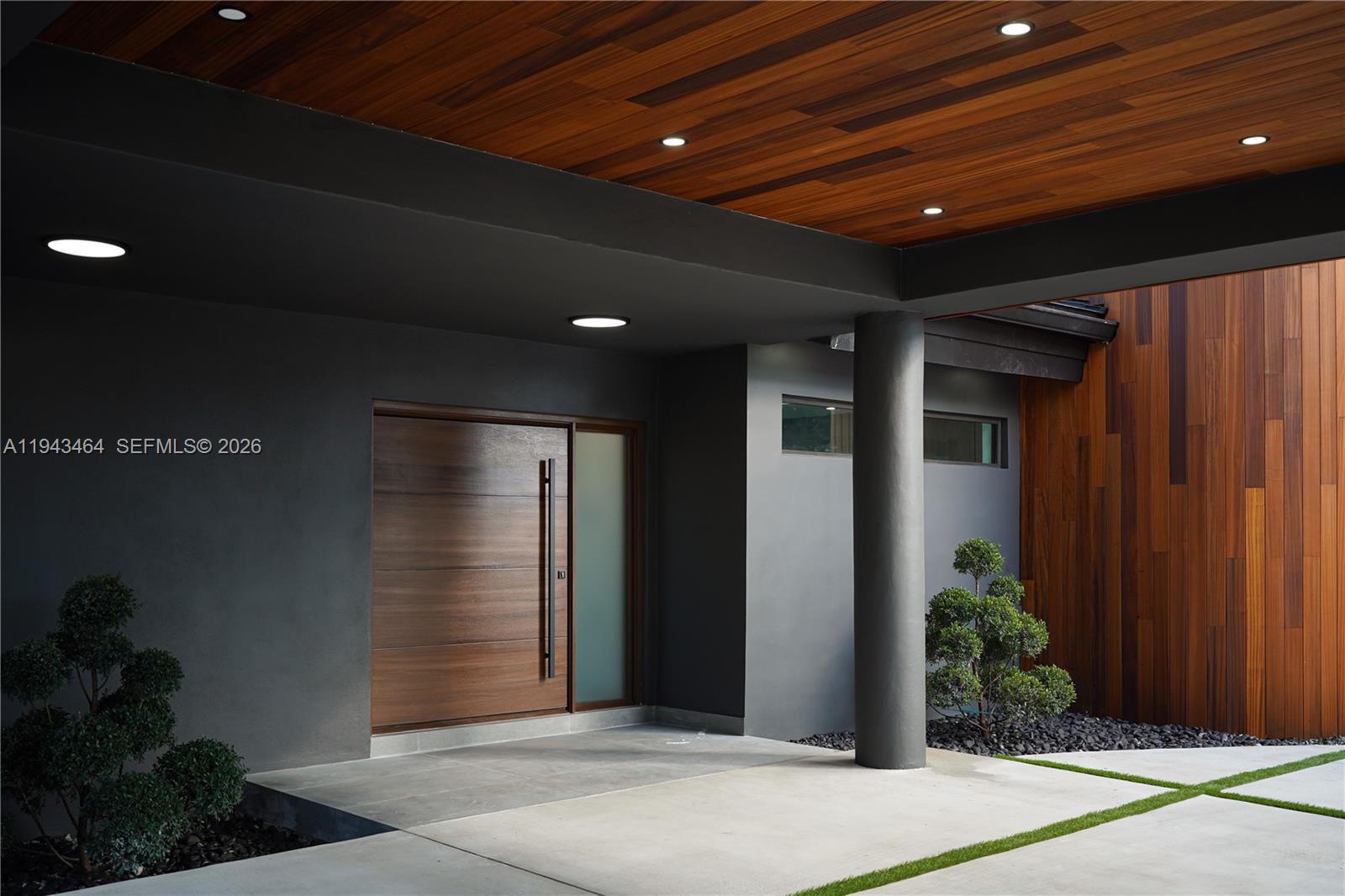 7765 Southwest 57th Terrace Miami, FL 33143 - Photo 5 of 52 a building with potted plants in front of door