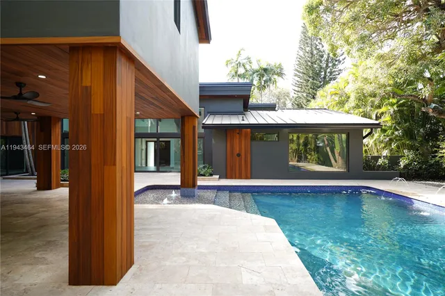 a view of a house with backyard porch and sitting area