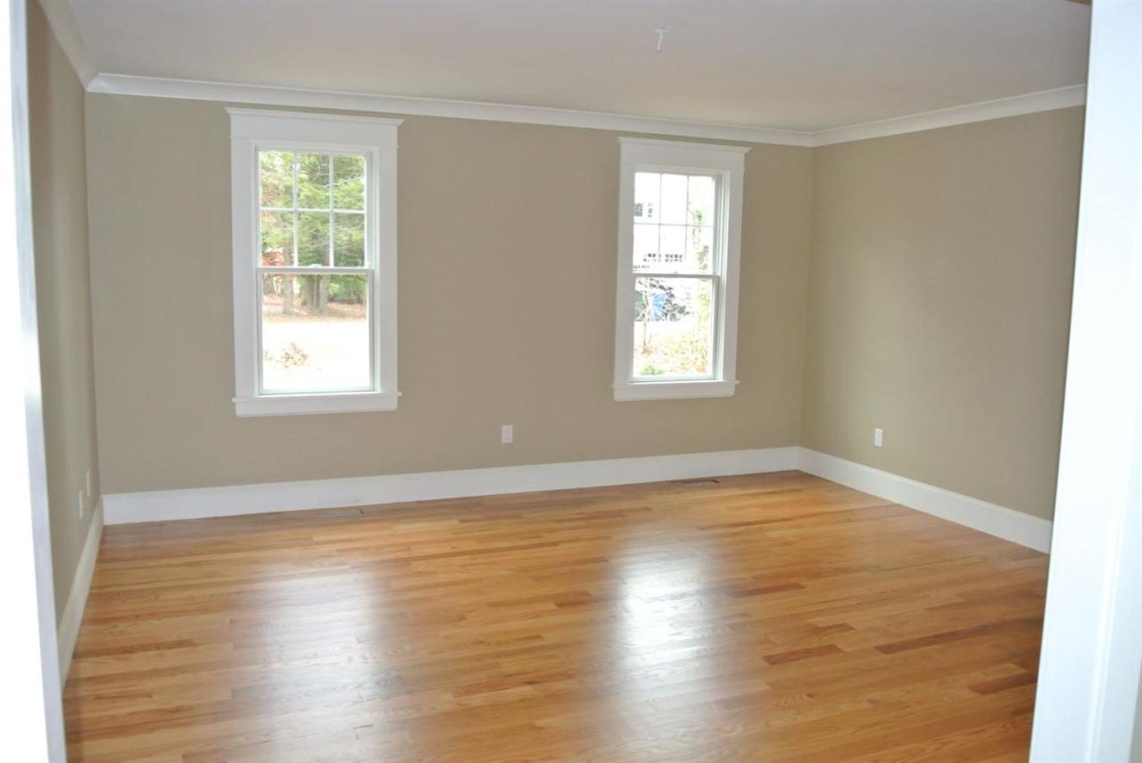 114 Summersea Road, Unit 90 Mashpee, MA 02649 - Photo 11 of 24 an empty room with wooden floor and windows