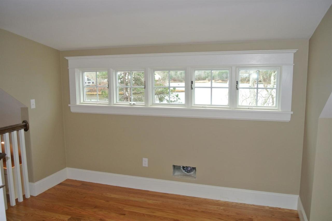 114 Summersea Road, Unit 90 Mashpee, MA 02649 - Photo 13 of 24 an empty room with wooden floor and windows