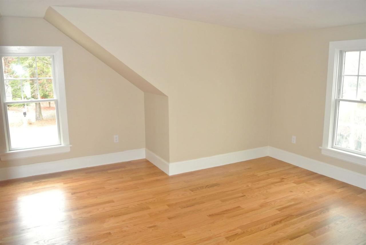 114 Summersea Road, Unit 90 Mashpee, MA 02649 - Photo 16 of 24 an empty room with wooden floor and windows