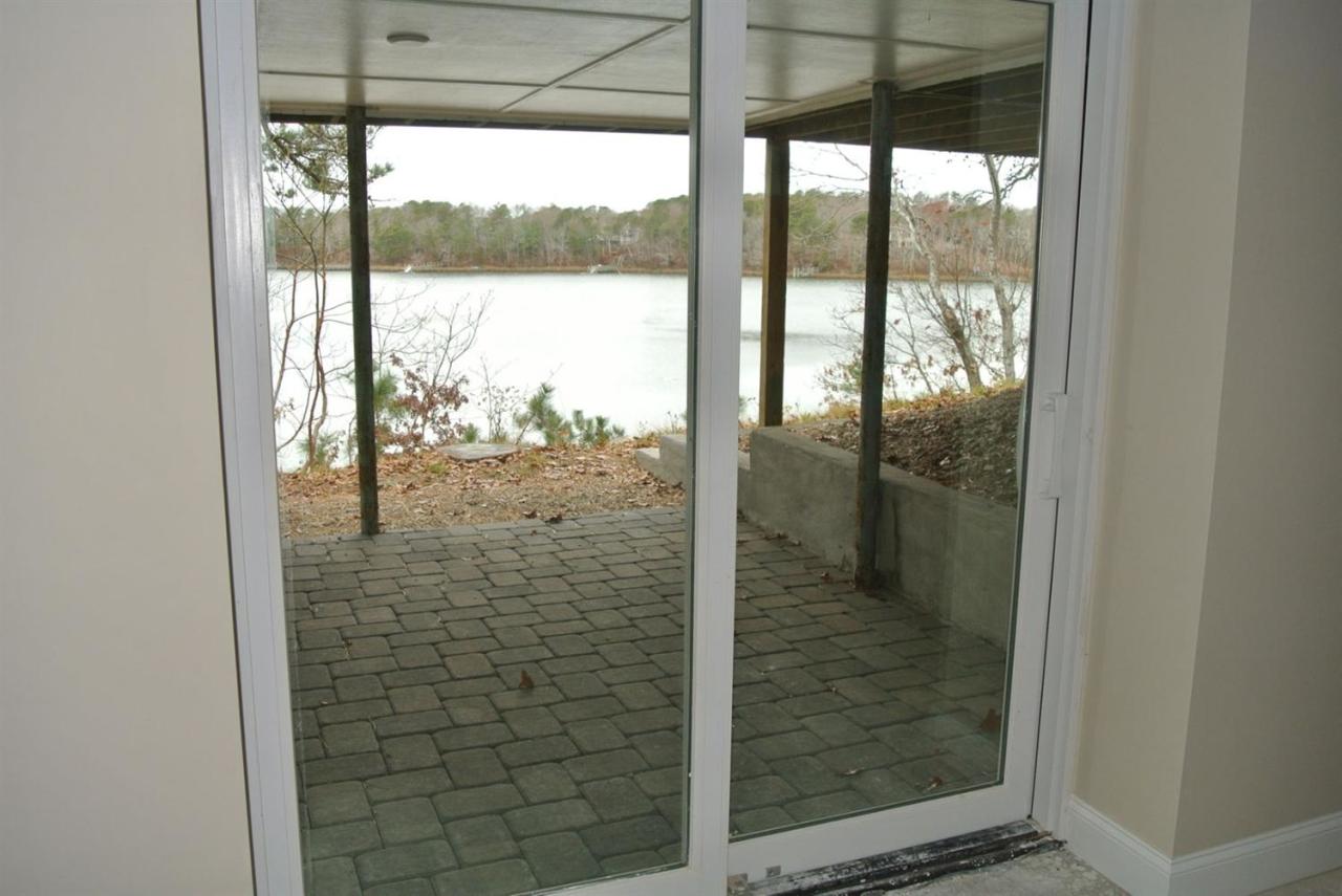 114 Summersea Road, Unit 90 Mashpee, MA 02649 - Photo 19 of 24 a bathroom with a glass shower door