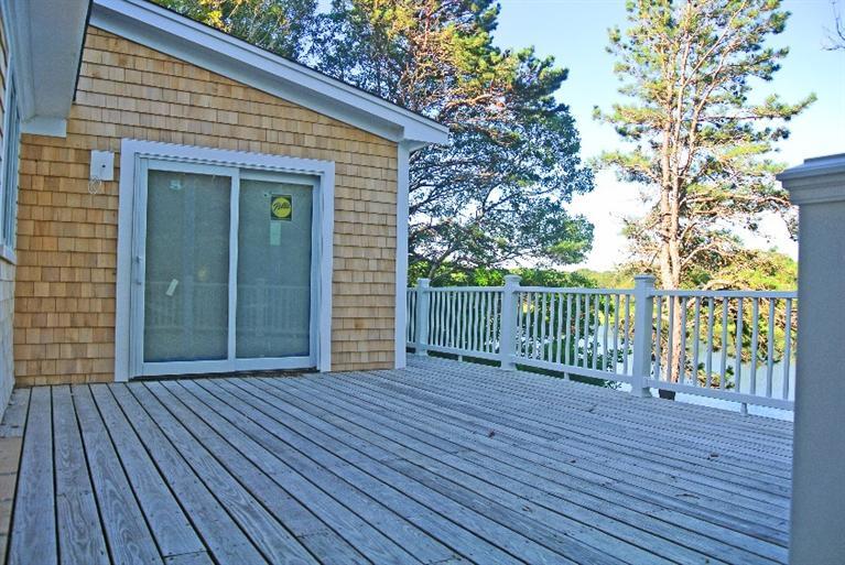 114 Summersea Road, Unit 90 Mashpee, MA 02649 - Photo 23 of 24 a view of a house with a deck