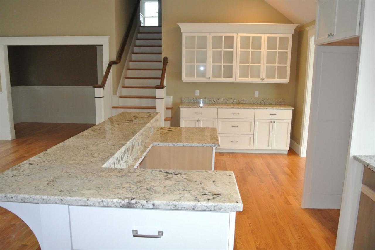 114 Summersea Road, Unit 90 Mashpee, MA 02649 - Photo 3 of 24 a kitchen with granite countertop a sink and a stove