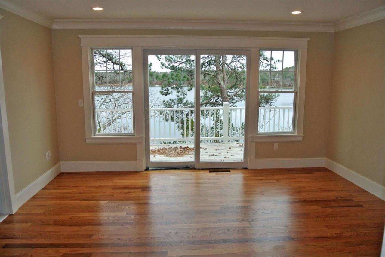 114 Summersea Road, Unit 90 Mashpee, MA 02649 - Photo 7 of 24 a view of an empty room with wooden floor and a window