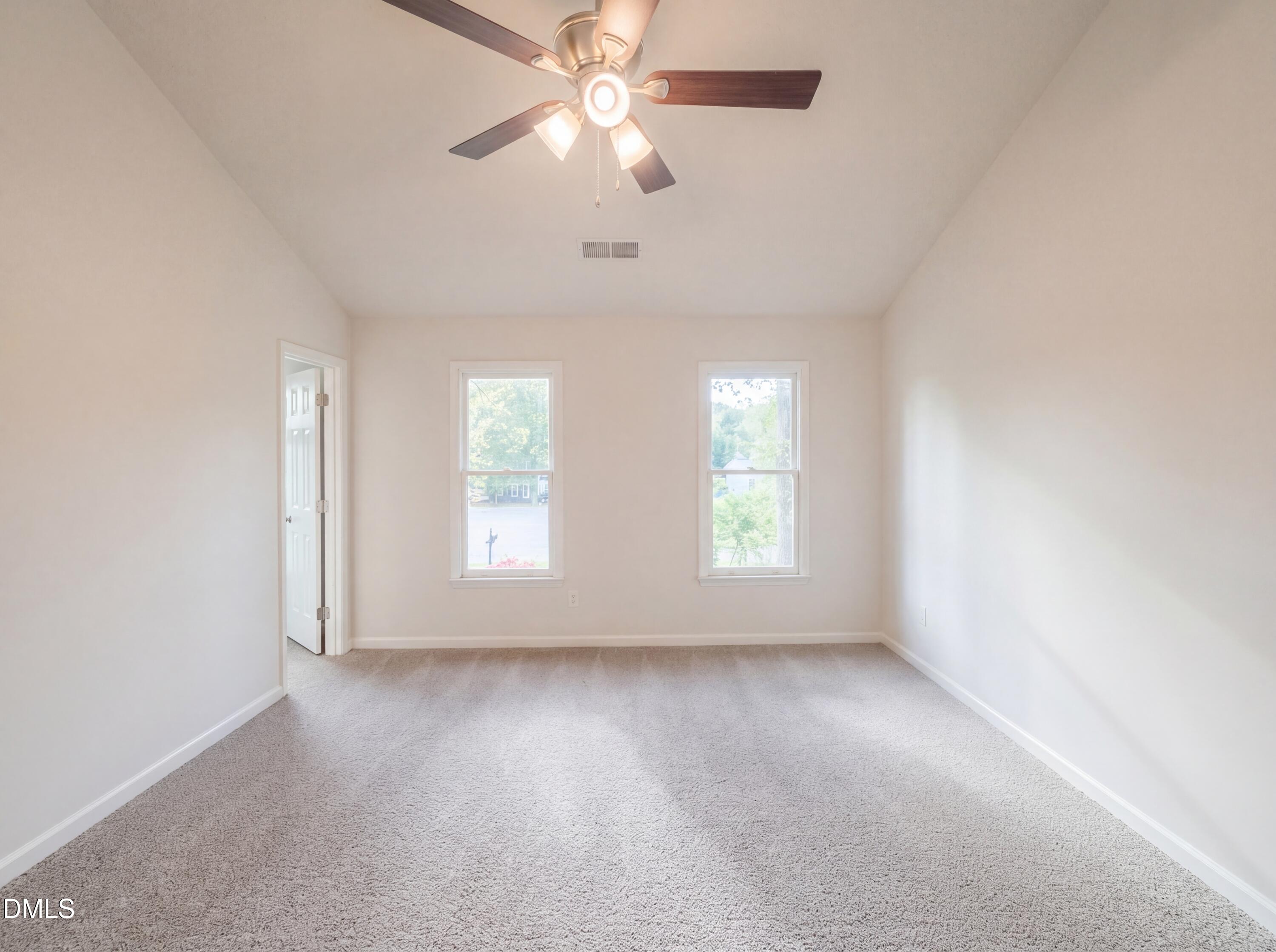 8988 Stamford Club Court Rural Hall, NC 27045 - Photo 14 of 22 an empty room with chandelier fan and windows