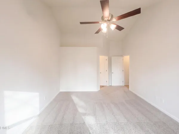 a view of a room with a ceiling fan and a window