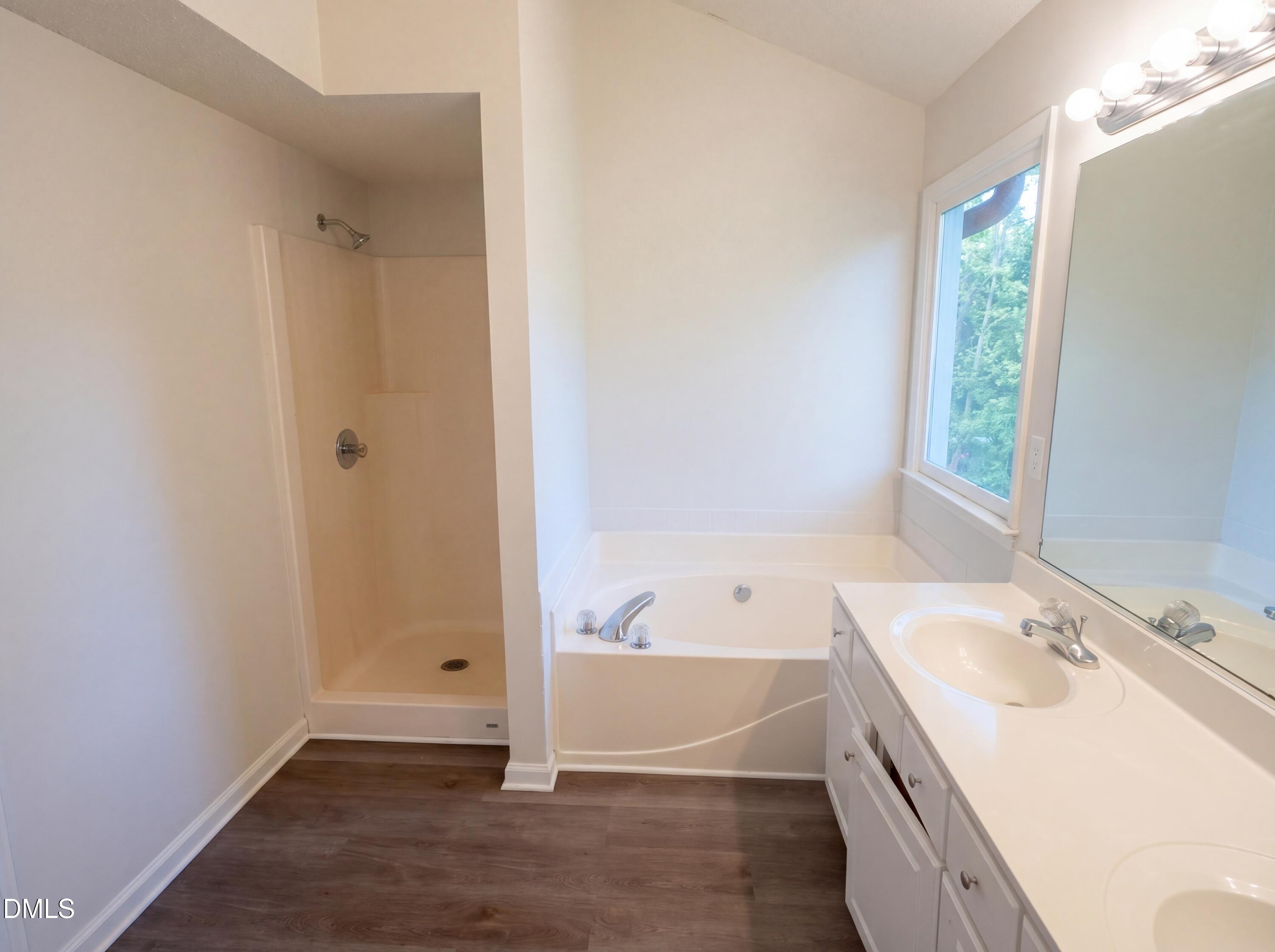 8988 Stamford Club Court Rural Hall, NC 27045 - Photo 20 of 22 a bathroom with a tub sink and a window