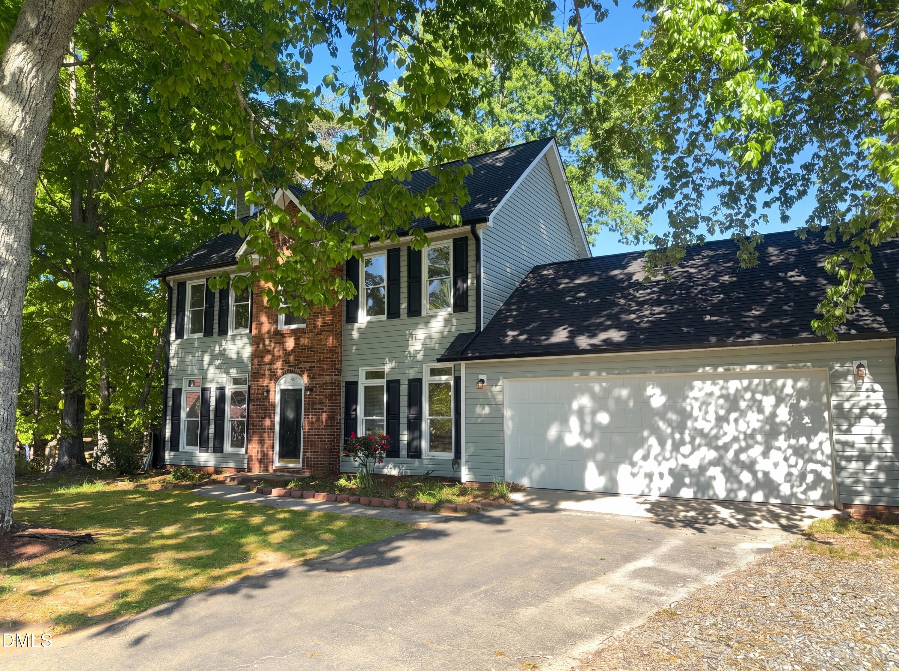 8988 Stamford Club Court Rural Hall, NC 27045 - Photo 2 of 22 a front view of a house with a garden