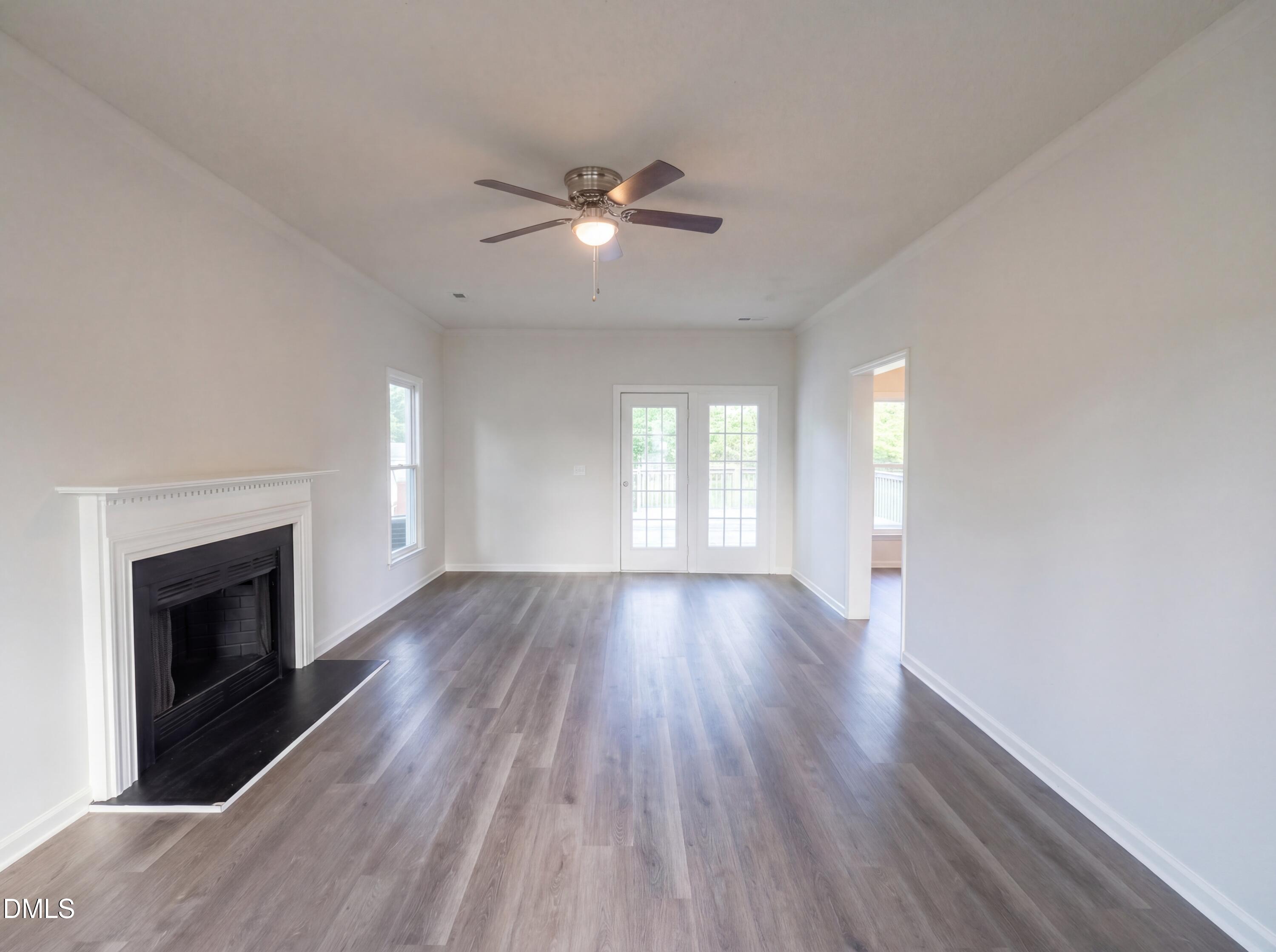 8988 Stamford Club Court Rural Hall, NC 27045 - Photo 4 of 22 a view of empty room with wooden floor and fireplace