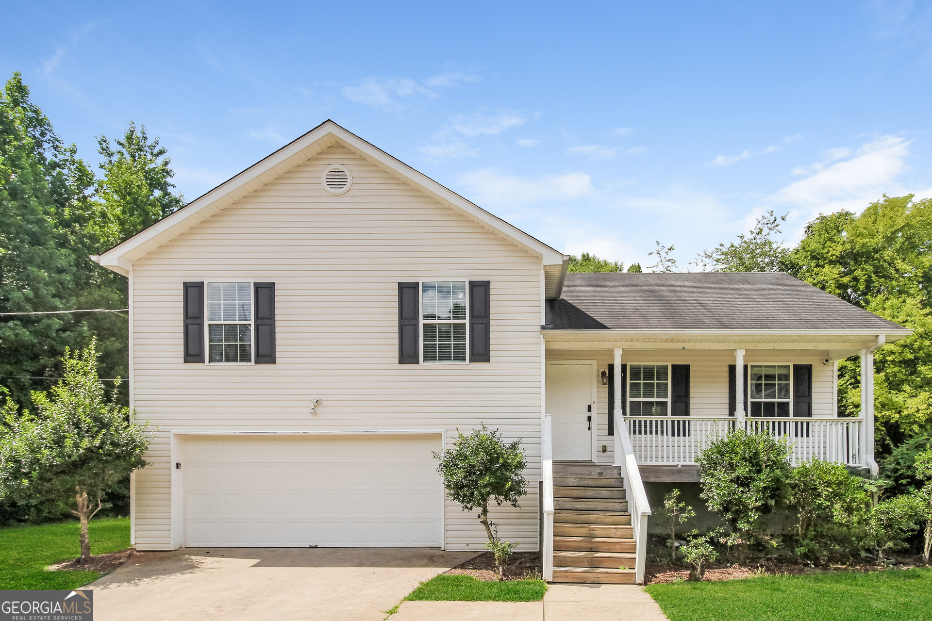 50 Thrasher Road Covington, GA 30016 - Photo 1 of 1 a front view of a house with a yard and garage
