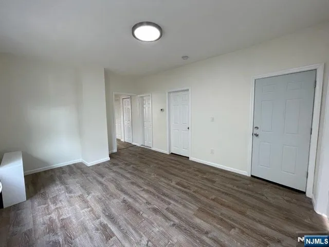 a view of an empty room and wooden floor