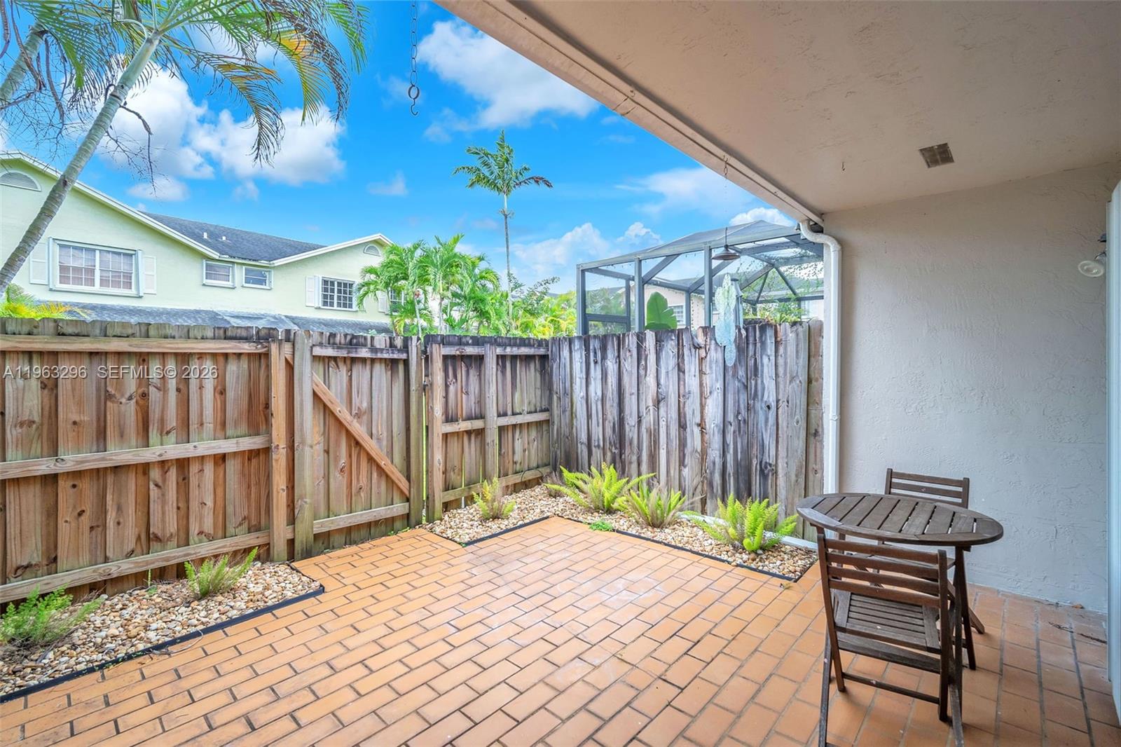 11864 Southwest 97th Terrace Miami, FL 33186 - Photo 13 of 32 a wooden bench sitting in front of a building