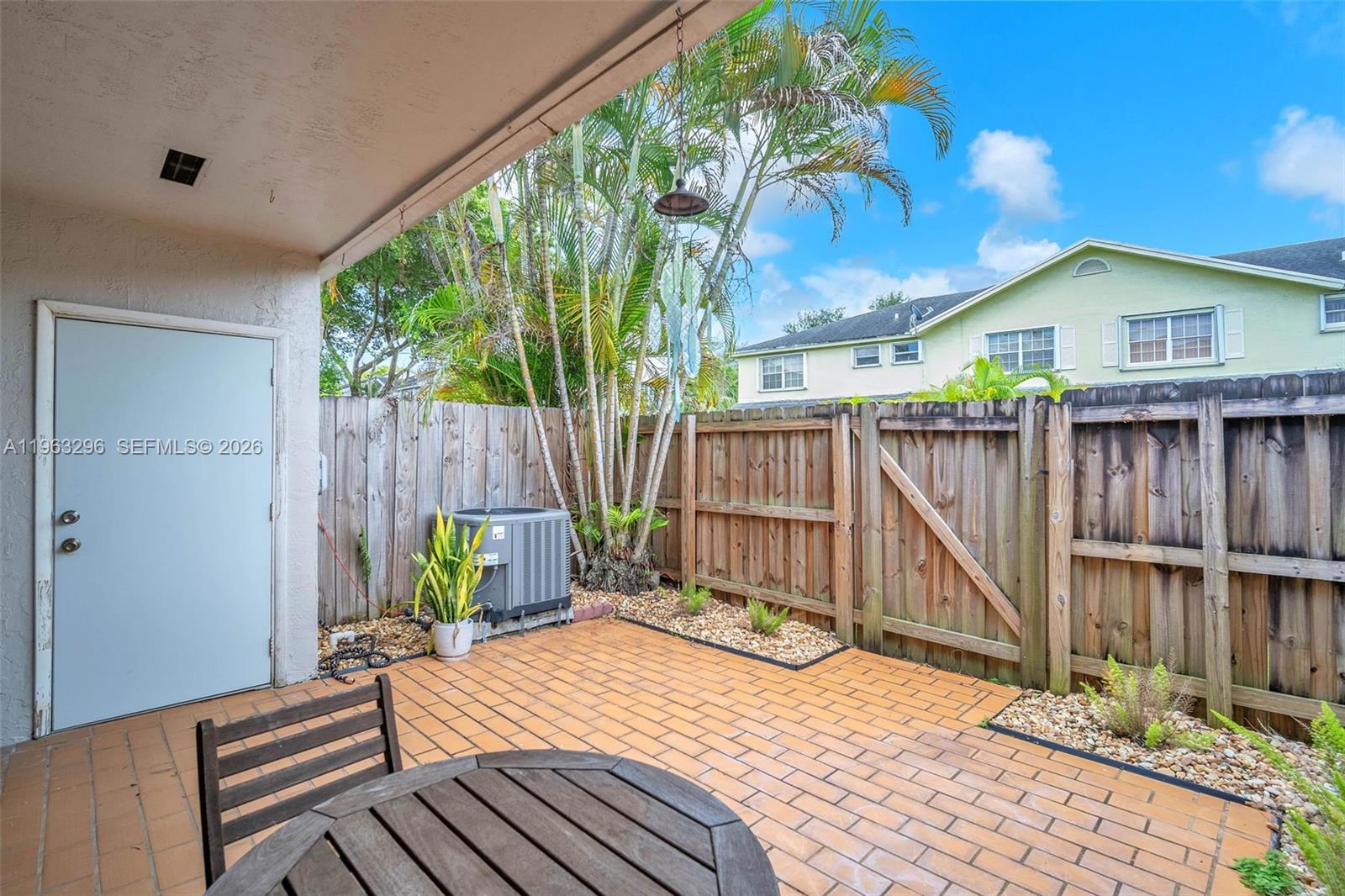 11864 Southwest 97th Terrace Miami, FL 33186 - Photo 14 of 32 a backyard of a house with table chairs and wooden fence