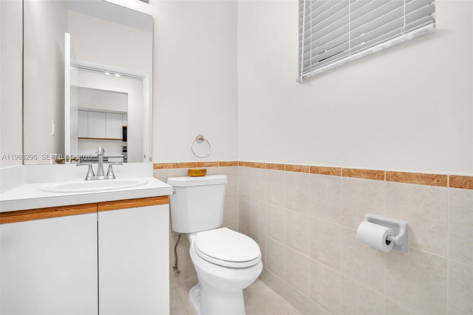 11864 Southwest 97th Terrace Miami, FL 33186 - Photo 16 of 32 a bathroom with a sink a toilet and a mirror