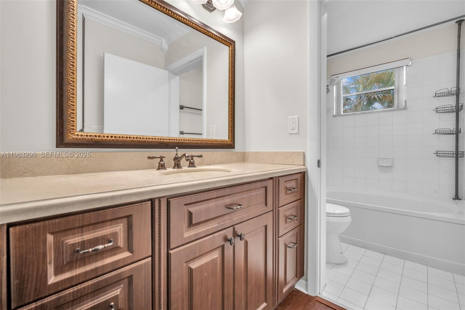 11864 Southwest 97th Terrace Miami, FL 33186 - Photo 19 of 32 a spacious bathroom with a granite countertop sink a toilet a and mirror