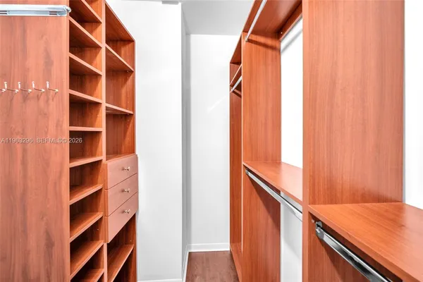 a view of walk in closet with empty racks