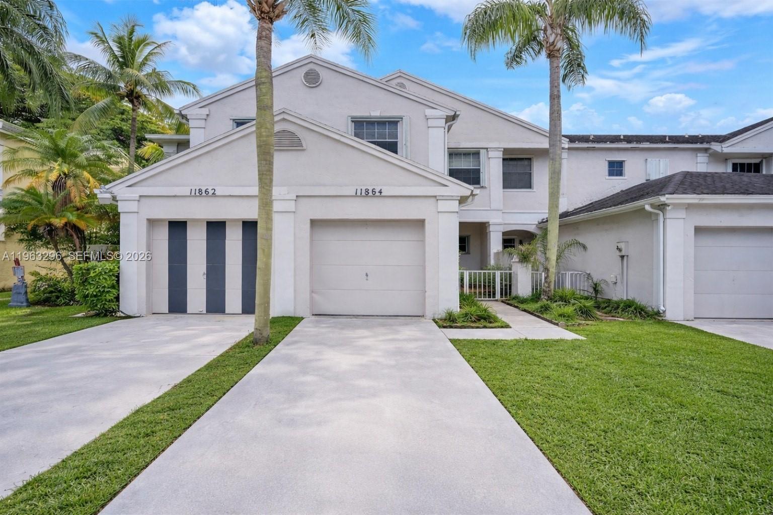 11864 Southwest 97th Terrace Miami, FL 33186 - Photo 2 of 32 a front view of a house with a yard and garage