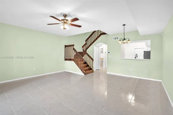 a view of a livingroom with a ceiling fan and wooden floor