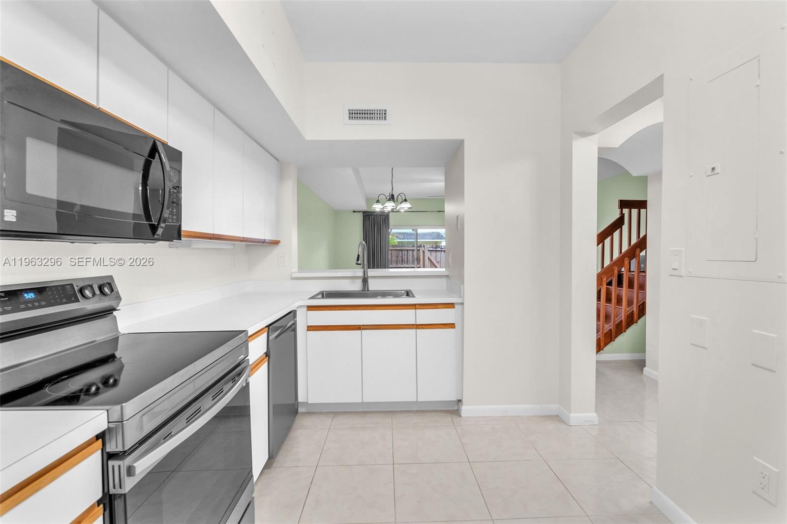 11864 Southwest 97th Terrace Miami, FL 33186 - Photo 8 of 32 a kitchen with stainless steel appliances a refrigerator and a stove top oven