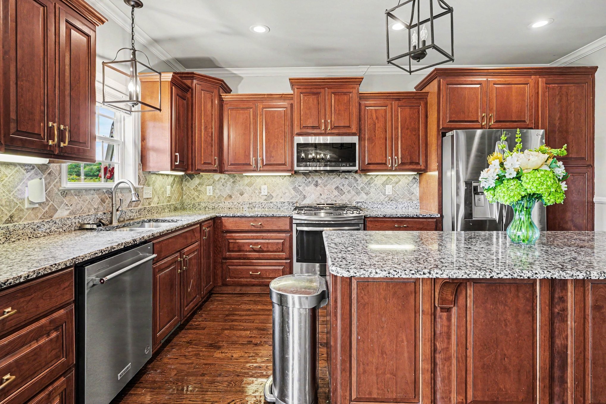 948 Goslin Branch Road Burns, TN 37029 - Photo 8 of 37 a kitchen with stainless steel appliances granite countertop a sink a stove top oven a counter space and cabinets