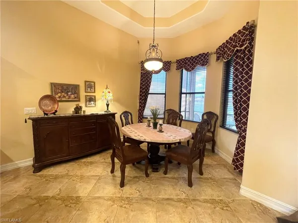 a dining room with a wooden table and chairs