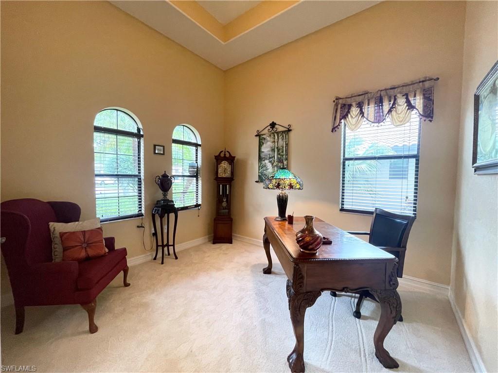 7302 Acorn Way Naples, FL 34119 - Photo 14 of 40 a living room with furniture and a window
