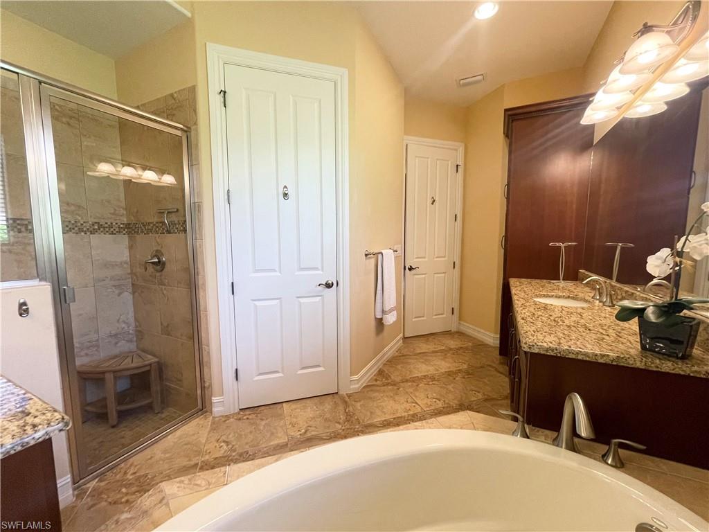 7302 Acorn Way Naples, FL 34119 - Photo 24 of 40 a bathroom with a granite countertop sink and a mirror