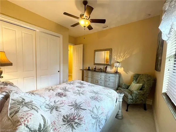 a bedroom with a bed couch and a window