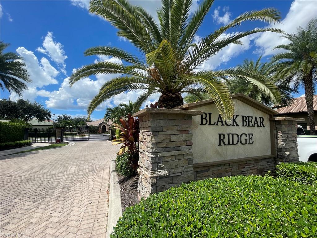 7302 Acorn Way Naples, FL 34119 - Photo 37 of 40 a view of a sign board and a yard