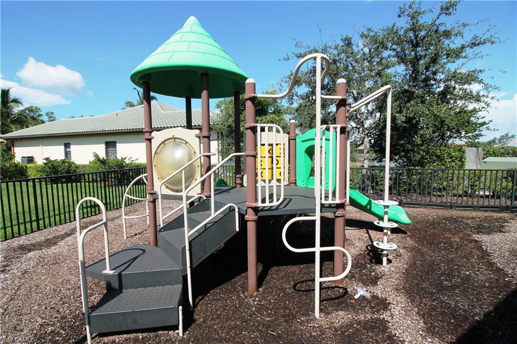 7302 Acorn Way Naples, FL 34119 - Photo 39 of 40 a backyard of a house with table and chairs