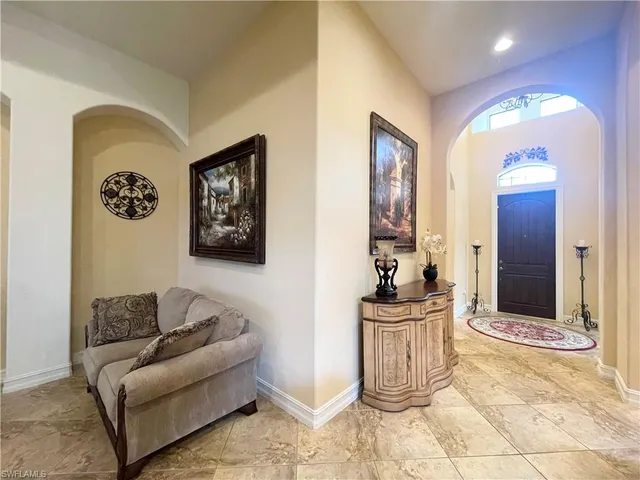 a living room with furniture and view of kitchen