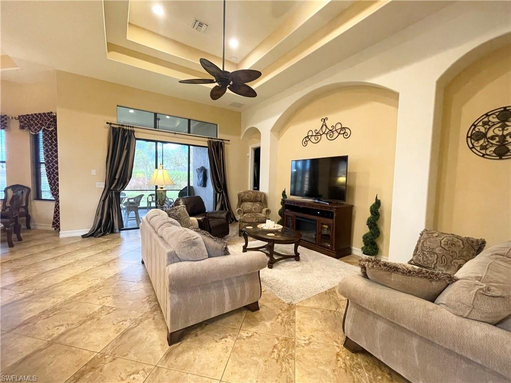 7302 Acorn Way Naples, FL 34119 - Photo 6 of 40 a living room with furniture and a flat screen tv