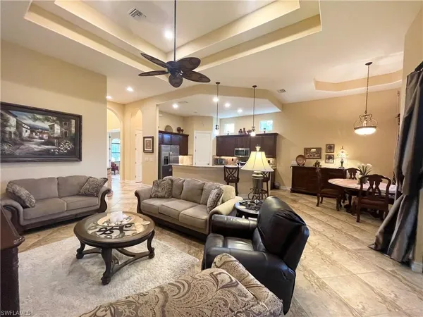 a living room with furniture and a chandelier